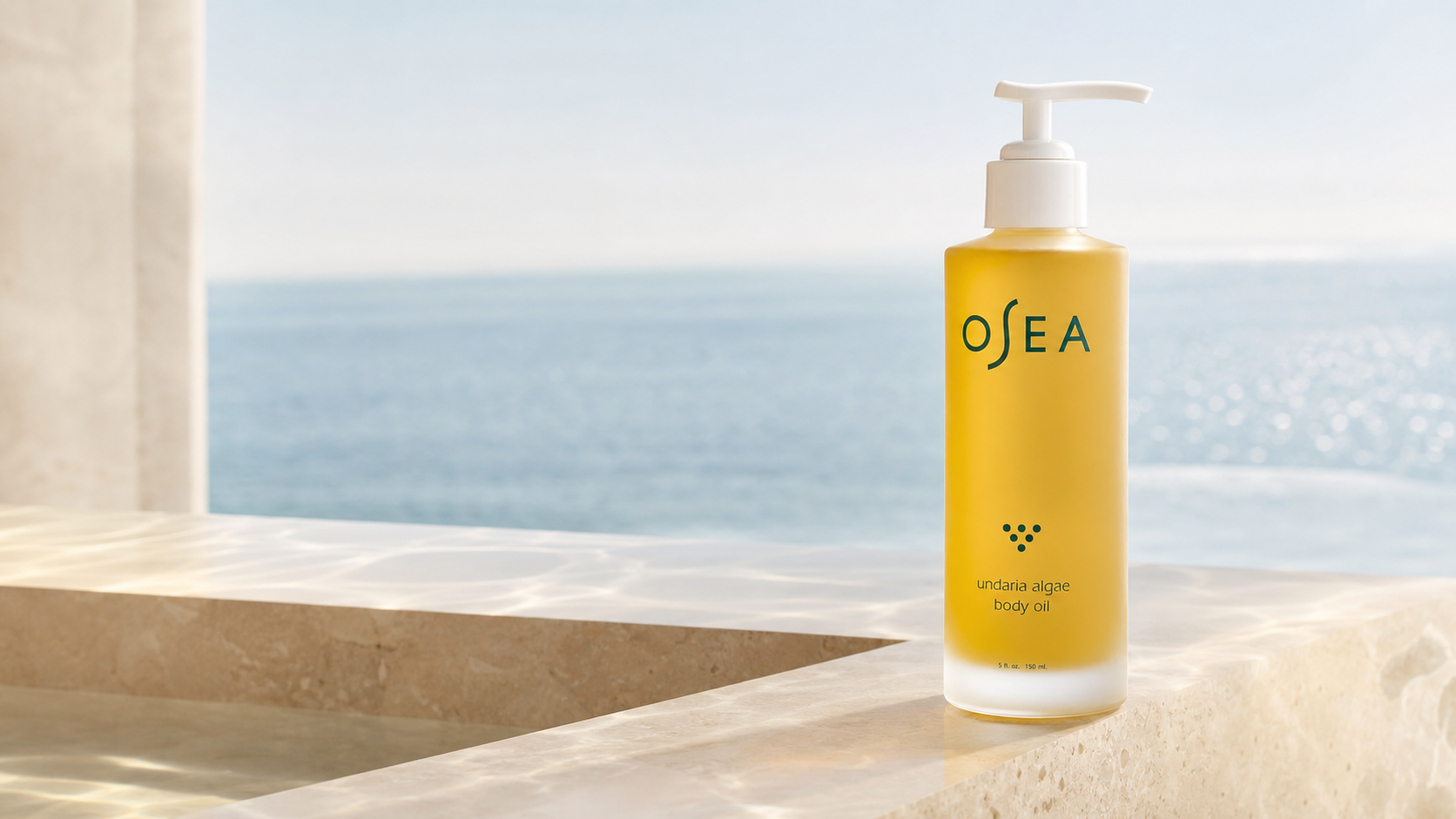 Undaria Algae Body Oil on a sunlit coastal stone vanity