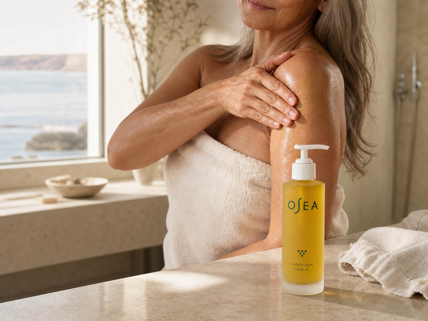 Body oil ritual in a naturally lit bathroom