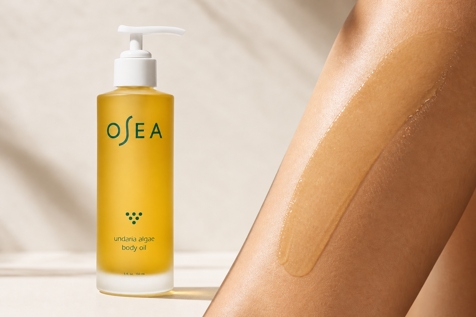 Golden body oil texture on skin beside the bottle